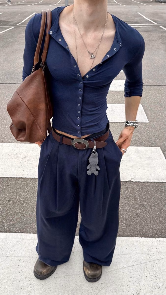 An androgynous menswear outfit with a narrow, layered silhouette.